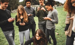 A group of young people on their phones