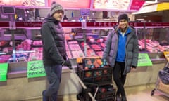 David and Jessica and a trolley full of groceries by a meat vendor in the Queen Victoria Market