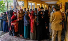 Voters queue to cast their ballot at a polling station in Muradnagar during the first phase of Uttar Pradesh state assembly elections.