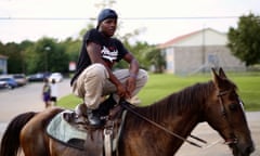 A young man crouched on a horse in the documentary Hale County This Morning, This Evening.