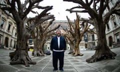 Chinese artist Ai Weiwei poses for photographers with his work "Tree" during a press preview at the Royal Academy in London on September 15, 2015, ahead of the opening of a major exhibition of his work. The exhibition runs from September 19 to December 13, 2015.   AFP PHOTO / LEON NEALLEON NEAL/AFP/Getty Images