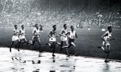 Competitors in the men’s 1500 metres race splash through the puddles.