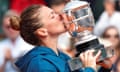 Simona Halep celebrates by kissing the trophy.