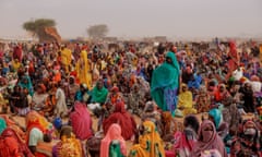 Refugees from Darfur, mostly women and children, wait for food distribution at a temporary camp in Chad.