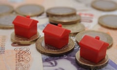 Monopoly houses on £1 and £2 coins on top of banknotes