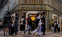 People walk past a Bvlgari store at a high-end shopping centre in Hong Kong