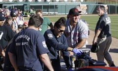 Tim Tebow comforts a fan who was suffering a seizure, following Tebow’s debut for the Scottsdale Scorpions against the Glendale Desert Dogs.