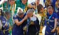 Chelsea manager Emma Hayes celebrates with the trophy next to Millie Bright.