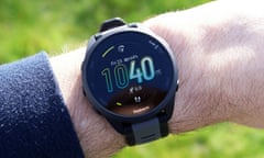 Garmin Forerunner 165 review showing the watch face on a wrist in sunlight.