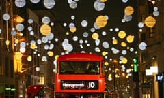 A bus plies its way down Oxford Street amid the Christmas lights.