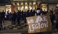 A masked protester in Trafalgar Square