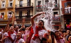 Revellers cheer as they are sprayed with water