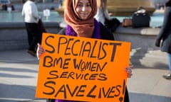 A campaigner against Rotherham council's closure of Apna Haq holds a sign in Trafalgar Square stating that specialist services for black and minority ethnic women save lives.