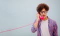 Portrait of young man talking on vintage telephone