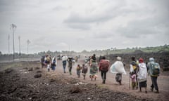 People flee fighting between Congolese forces and M23 rebels near Kibumba, north of Goma.