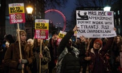 Protesters holding placards demonstrate outside Downing Street against Donald Trump’s ban on travel from seven Muslim-majority countries.