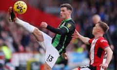 Pascal Gross of Brighton stretches for the ball under pressure from Ben Osborn of Sheffield United