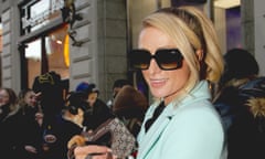 Paris Hilton wearing sunglasses and a pale blue jacket