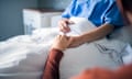 Woman holding hand of someone in hospital.