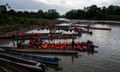 people with life jackets sit in boats