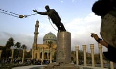 ** FILE ** A U.S. marine watches a statue of Saddam Hussein being toppled in Firdaus Square, in downtown Bagdhad in this April 9, 2003 file photo. A car bomb  destroyed a hotel in central Baghdad on Wednesday night, March 17, 2004, behind Firdaus Square, killing at least 10 people according to Iraqi police and U.S. soldiers. (AP Photo/Jerome Delay, File)