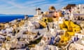 White and yellow buildings with blue sea and sky in background