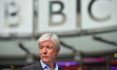 Tony Hall beneath a BBC sign