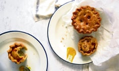 Pork pies on a plate with a dab of mustard