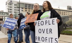 Protesters with signs outside of the 2022 Berkshire Hathaway shareholders meeting.