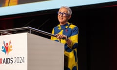 A middle-aged white women standing on a stage talking to an unseen audience