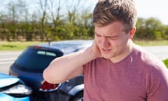 Man holds his neck after a car crash