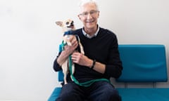 A man holds a chihuahua