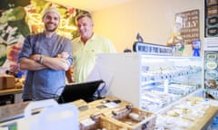 Simon and Oli Dunn stand behind counter of chocolate shop