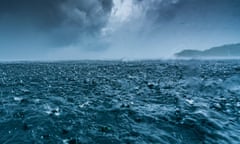 A picture of a choppy, deep-blue ocean with menacing clouds overhead