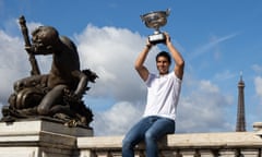 Rafael Nadal poses with his trophy on the Alexandre III bridge in front of the Eiffel Tower a day after winning his 14th French Open title.