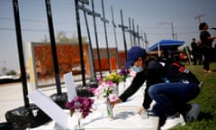 Tribute to the victims of the 2019 Walmart shooting in El Paso<br>An activist lays flowers during a tribute to the victims of the August 3, 2019 Walmart shooting in El Paso, at Ponder Park in El Paso, Texas, U.S., August 3, 2021. REUTERS/Jose Luis Gonzalez