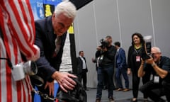 Shadow chancellor John McDonnell greets a dog at Labour’s party conference, Liverpool, on Tuesday.