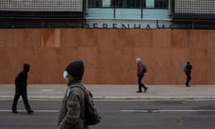 Shoppers walk past closed Debenhams