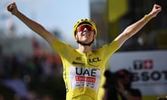 Tadej Pogacar crosses the finish line to win the 15th stage of the Tour de France.