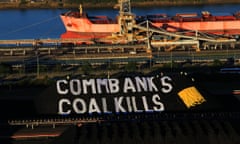 Greenpeace activists have unveiled a giant banner on Newcastle coal stockpiles, calling on the Commonwealth Bank to stop investing money in coal