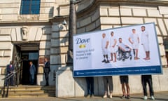 Security guards look on as Ukraine Solidarity Security guards look on as Ukraine Solidarity Project protesters hold a billboard – featuring pictures of wounded Ukrainian soldiers posing in the style of the Dove beauty brand's adverts – outside the Unilever HQ in London.