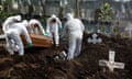 Outbreak of the coronavirus disease (COVID-19) in El Salvador<br>Cemetery workers move the coffin of a woman, who died of the coronavirus disease (COVID-19), during her funeral, at the Santa Tecla cemetery, as the coronavirus disease (COVID-19) outbreak continues, in Santa Tecla, El Salvador June 24, 2020. REUTERS/Jose Cabezas