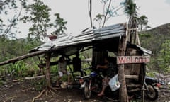 Shack with 'welcome' sign nailed outside