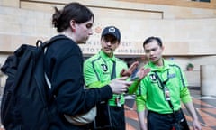 Los Angeles Metro ambassadors Gilberto Morales and Richard Nguyen help a transit rider in June 2024.