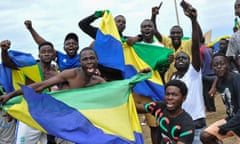 young men waving flags with fists in air