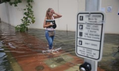 A resident walks through the flooded streets of Miami Beach in 2015.