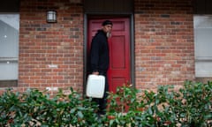 Roderick Readus carries a reusable water container outside his apartment in Jackson, Mississippi on March 2, 2021. Photo by Rory Doyle for The Guardian.