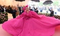 The singer/actor Lady Gaga wears a bright pink gown at the 2019 Met Gala event in New York City.