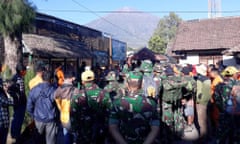 Indonesian soldiers and rescue team gather to prepare for evacuating tourists from Mount Rinjani