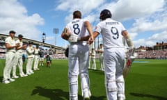 Stuart Broad is pushed ahead by James Anderson to receive a guard of honour from Australia